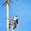 electrical lineman working stock photo