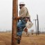 electrical linemen carry on the climb