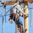 electrical lineman working on lines