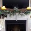 a mantel with a tv above it for christmas